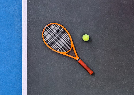 Tennis racket and ball on a tennis court