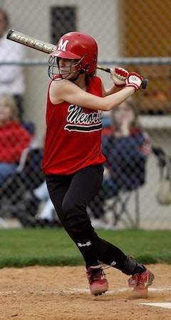 A woman playing baseball.
